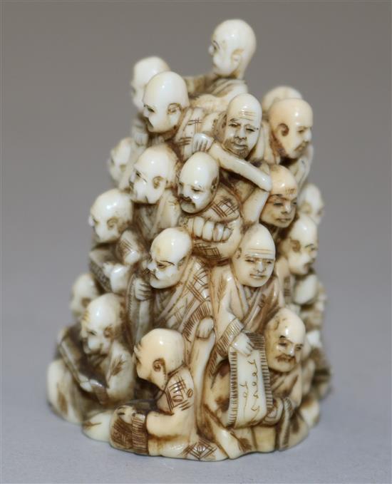 A Japanese ivory netsuke of multiple rakan, Meiji period, height 5.6cm
